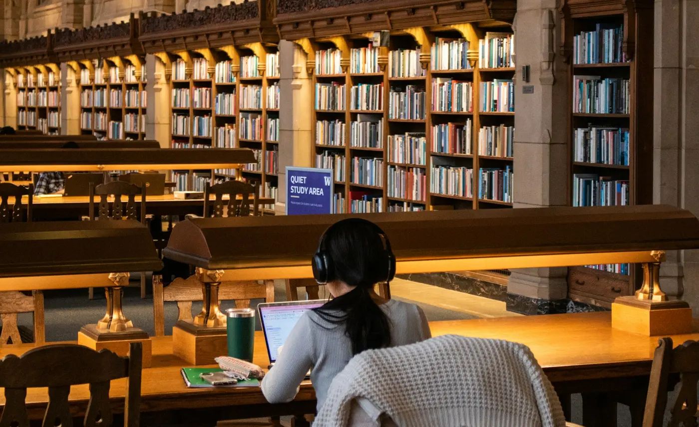 University student researching independently in a library