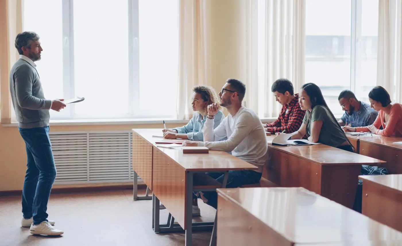 University lecturer guiding students in a modern classroom